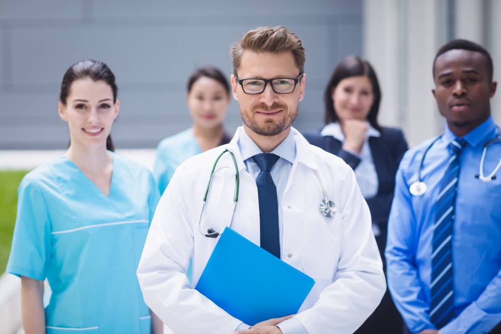 team doctors standing together hospital premises Medium